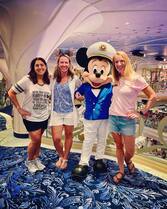 Front view of Disney World with the Walt Disney and Mickey Mouse statue in front